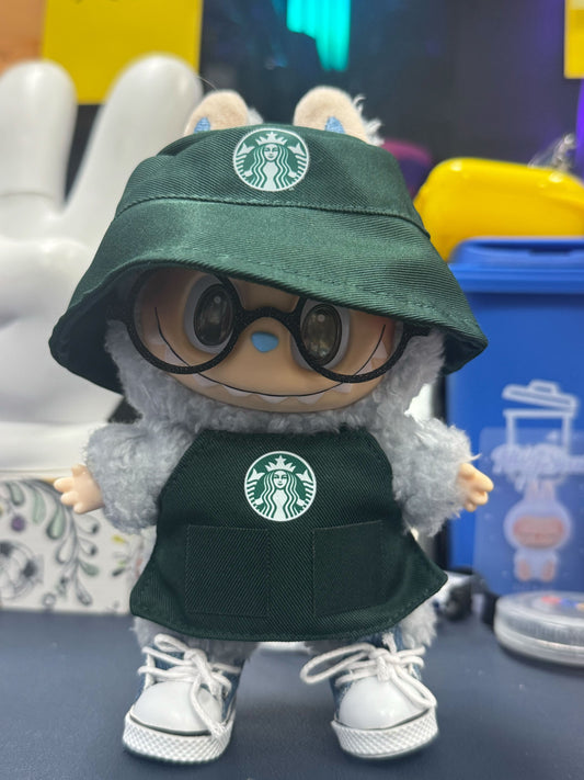 Labubu doll dressed in Starbucks-inspired green barista uniform with apron and glasses, ideal for coffee-themed photo shoots.