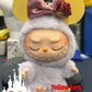 Adorable Labubu doll with yellow ears, rose gold bow, and fuzzy outfit, perfect for collectors and Disney fans.